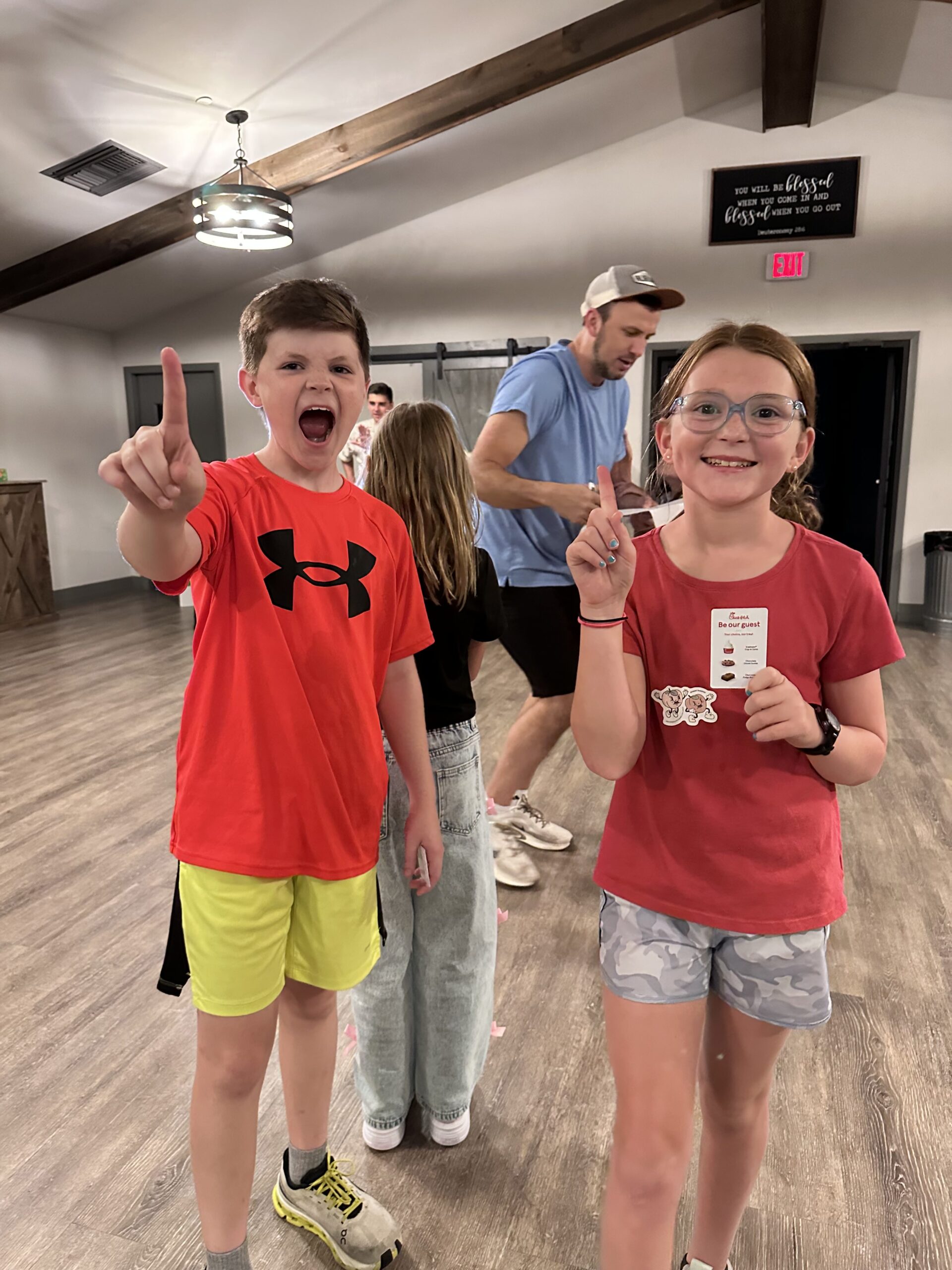 two students after a win among other tweens at church