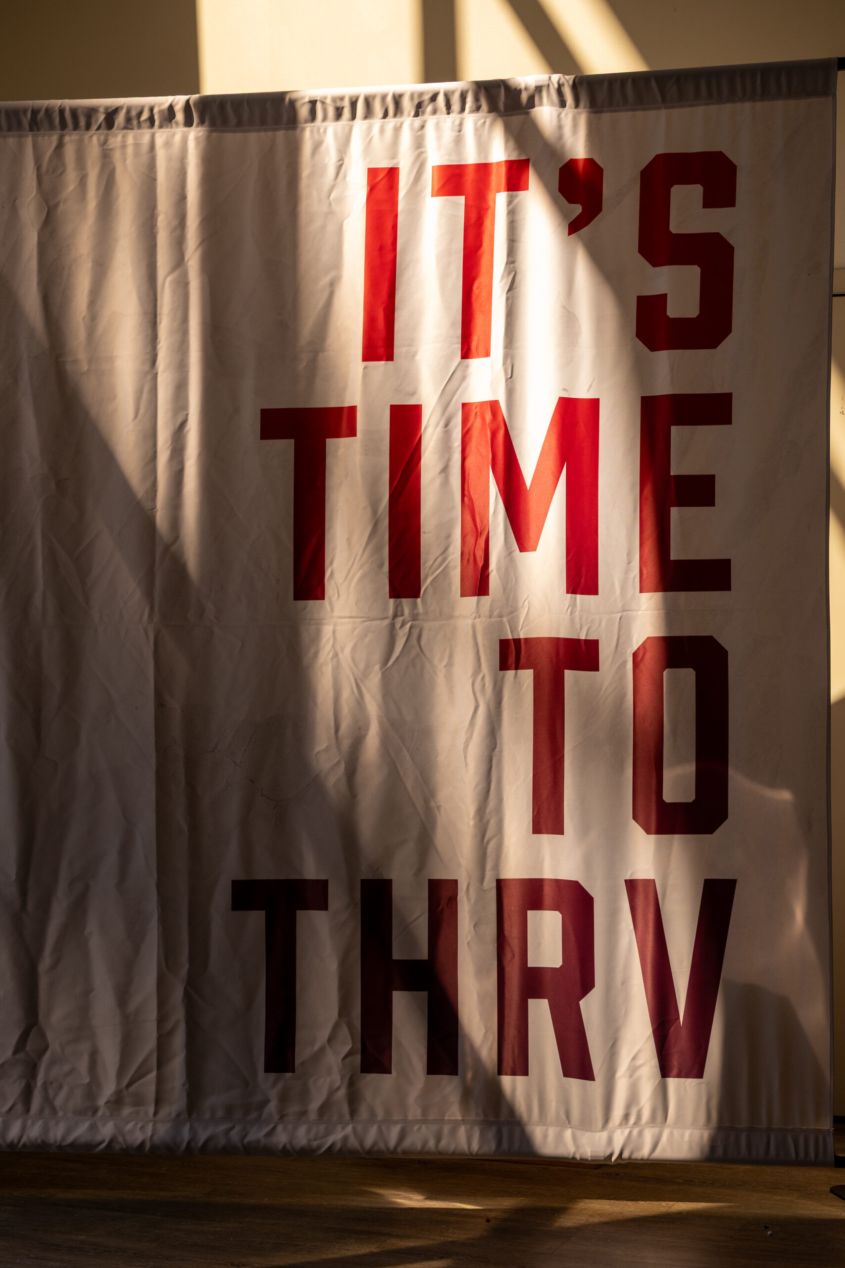 red and white banner that reads "it's time to thrv"
